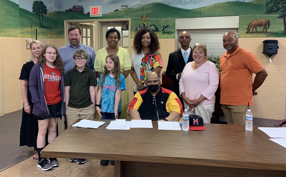 MMS student William Wall with the MCPS School Board, his family, and MMS English teacher Lauryn Talley and Superintendent Dr. Zeb Talley