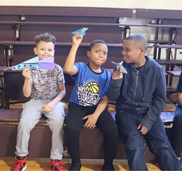 AHES students holding paper airplanes