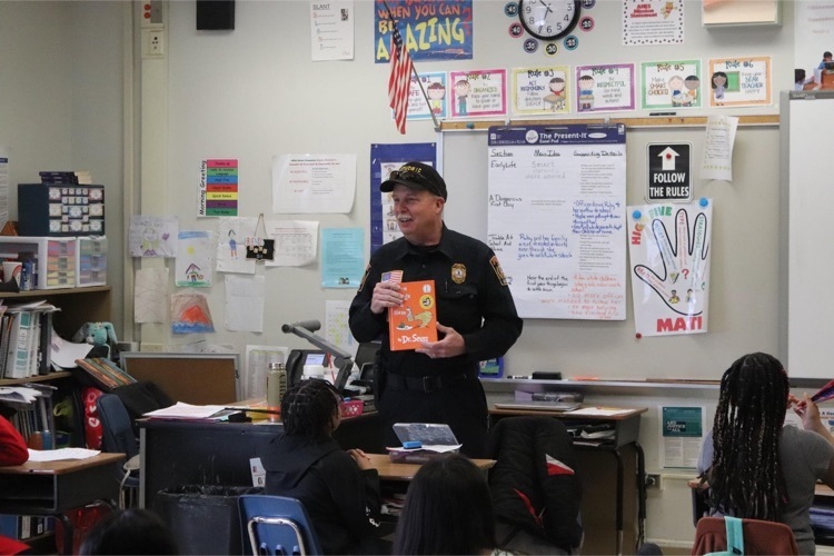 Former Martinsville Fire Chief Ted Anderson reads to a group of elementary school students
