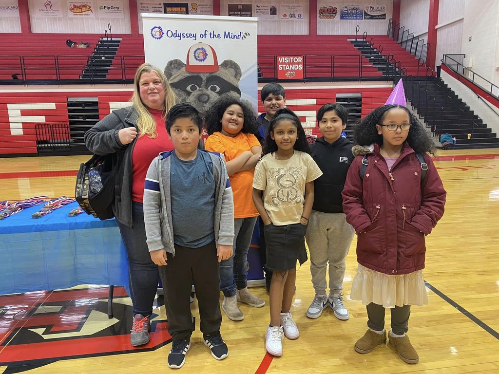 AHES Odyssey of the Mind Team poses with coach