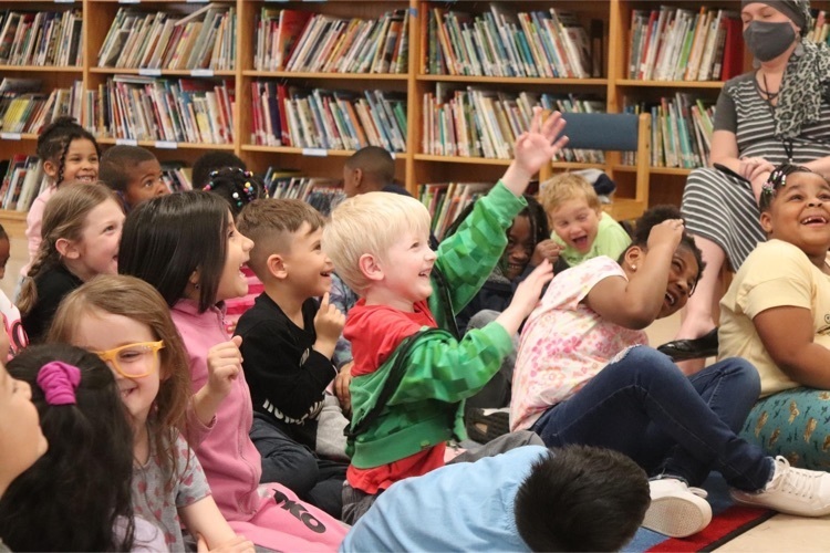 PHES kindergarten students smile and laugh during the Tooth Fairy presentation 