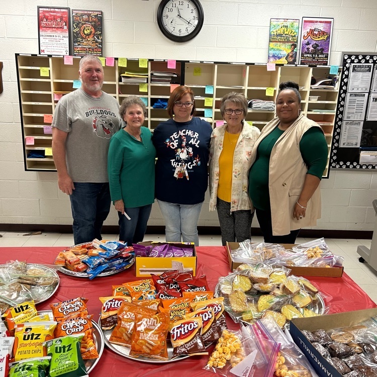 MMS staff pose in front of a table of food