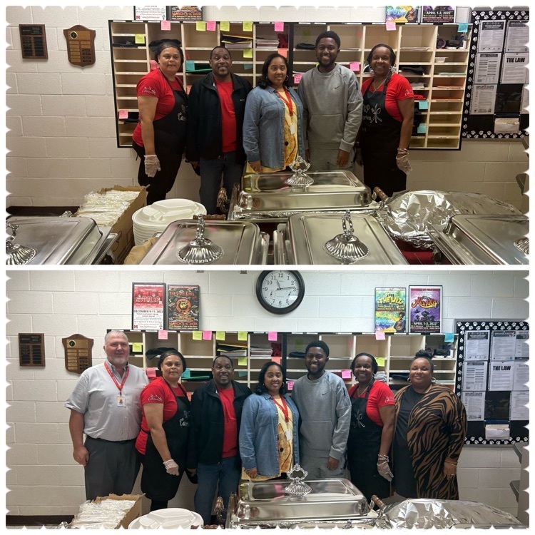 MMS staff pose in front of a table of food