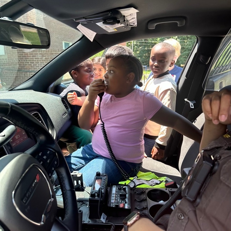 Students test out the radio in a police car